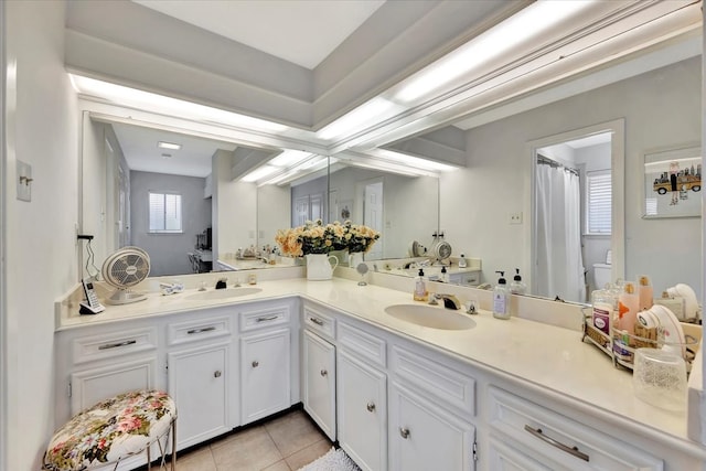 bathroom with vanity, tile patterned flooring, and toilet