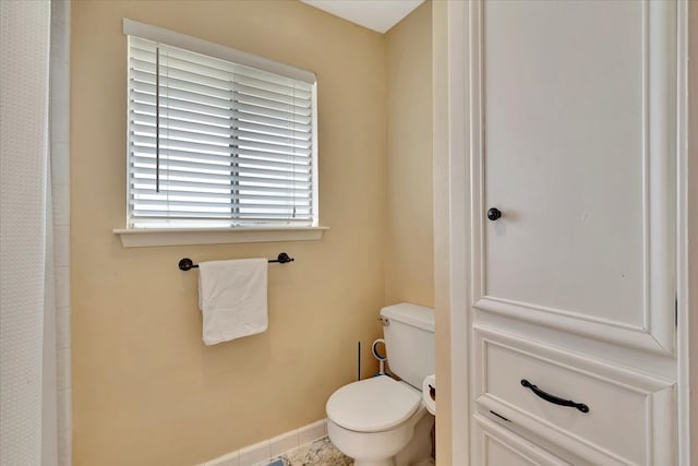 bathroom featuring toilet and a shower with shower curtain