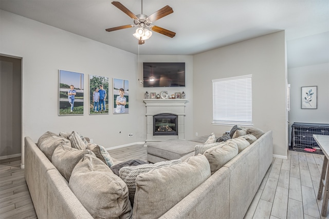 living room with ceiling fan and light hardwood / wood-style flooring