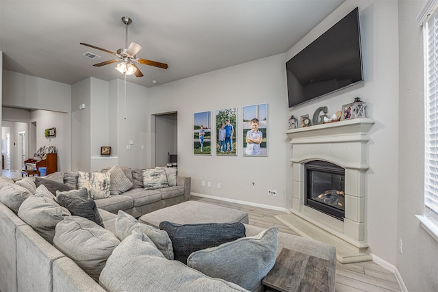 living room with ceiling fan and light hardwood / wood-style flooring