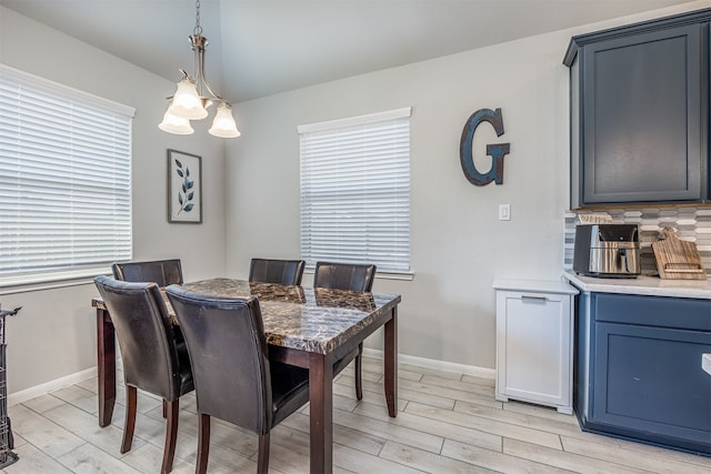 dining room featuring a notable chandelier and light hardwood / wood-style flooring