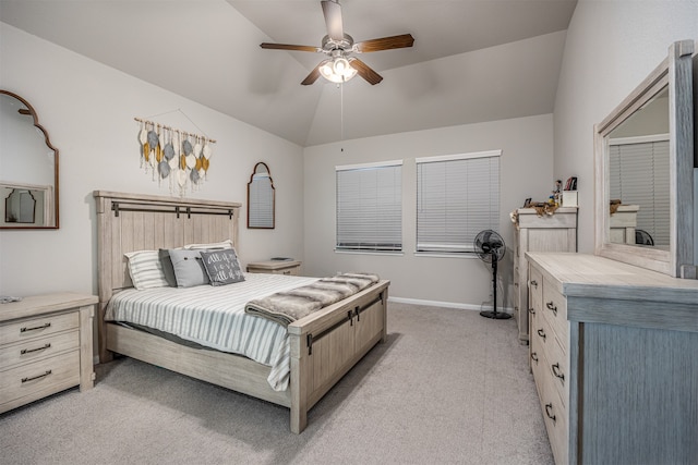 bedroom with light colored carpet, vaulted ceiling, and ceiling fan