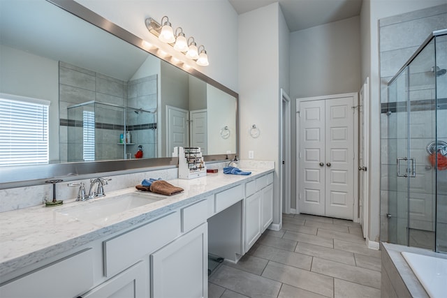 bathroom with tile patterned floors, vanity, and a shower with shower door