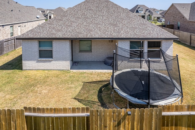 rear view of property with a yard and a patio