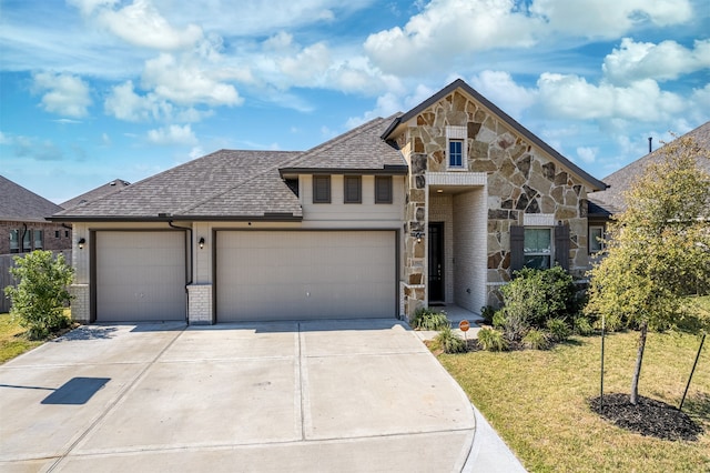 view of front facade with a front yard and a garage