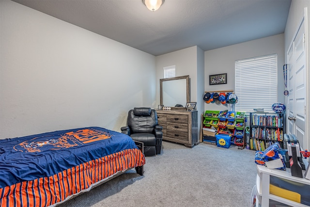 bedroom with carpet flooring and a textured ceiling