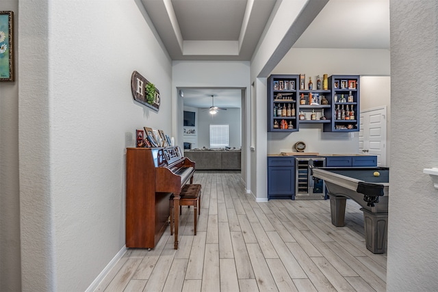 corridor with wine cooler and light hardwood / wood-style floors