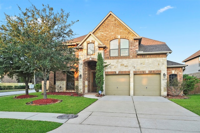 view of front of property featuring a garage and a front yard