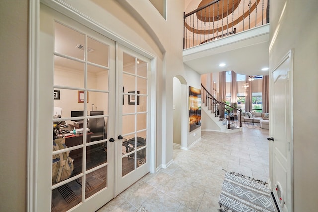 foyer entrance with french doors and a high ceiling