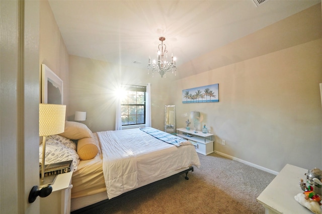 carpeted bedroom featuring an inviting chandelier