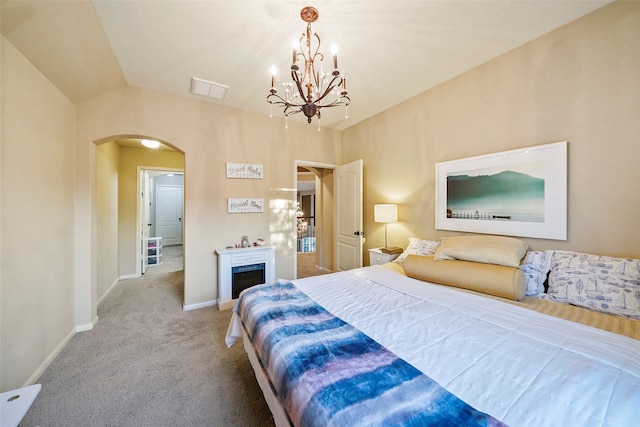 bedroom featuring carpet flooring, an inviting chandelier, and lofted ceiling