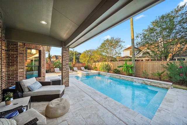 view of swimming pool featuring a jacuzzi and a patio area