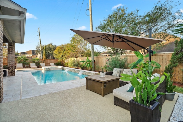 view of pool with an outdoor hangout area, pool water feature, and a patio area