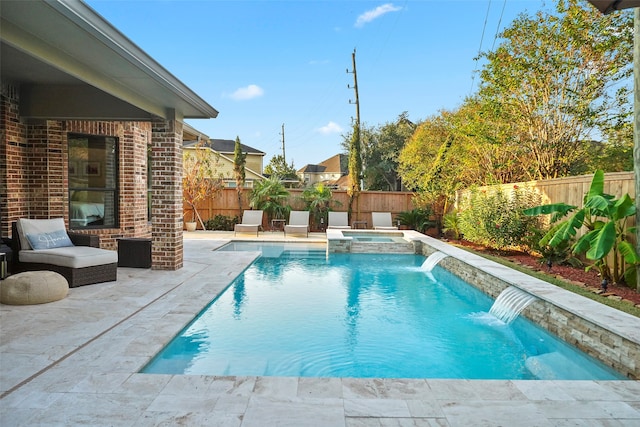 view of swimming pool with pool water feature, a patio area, and an in ground hot tub