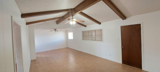 tiled empty room featuring ceiling fan and vaulted ceiling with beams