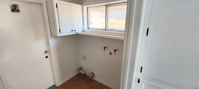 washroom with hookup for a washing machine and cabinets