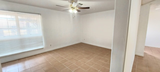 unfurnished room featuring ceiling fan and light tile patterned floors