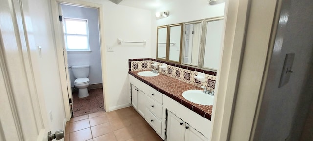 bathroom with decorative backsplash, tile patterned floors, vanity, and toilet