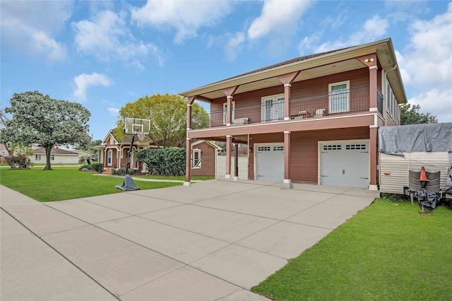 view of front of home with concrete driveway, an attached garage, a balcony, and a front lawn