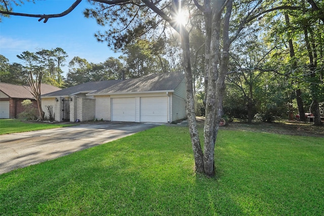 ranch-style home featuring a front yard and a garage