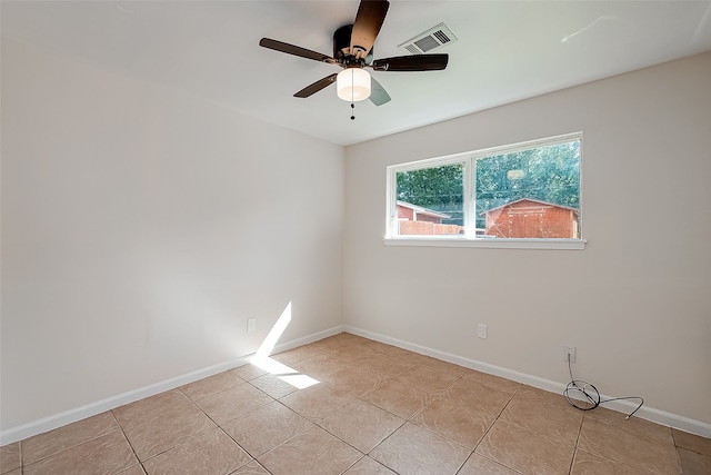 tiled empty room with ceiling fan