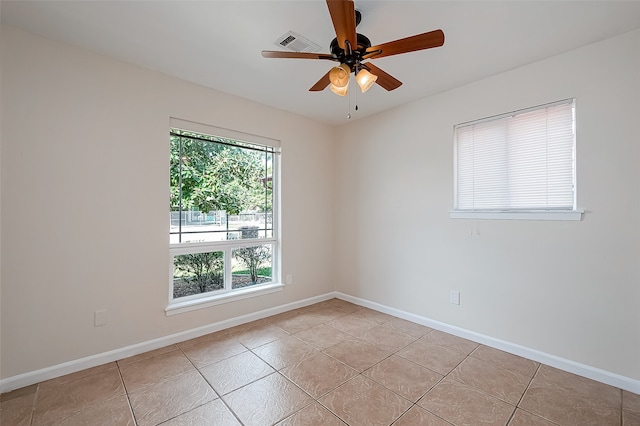 unfurnished room with ceiling fan and light tile patterned floors