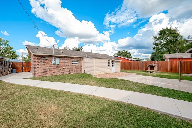 back of property with a patio and a lawn