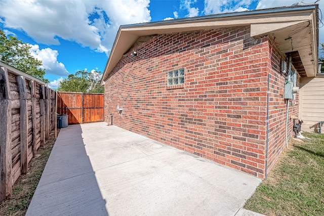 view of property exterior with a patio area