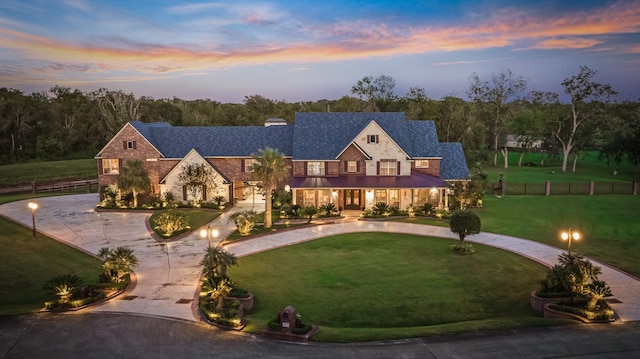 view of front of home featuring a lawn and a garage