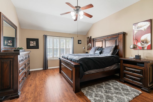 bedroom featuring ceiling fan, dark wood-type flooring, and vaulted ceiling