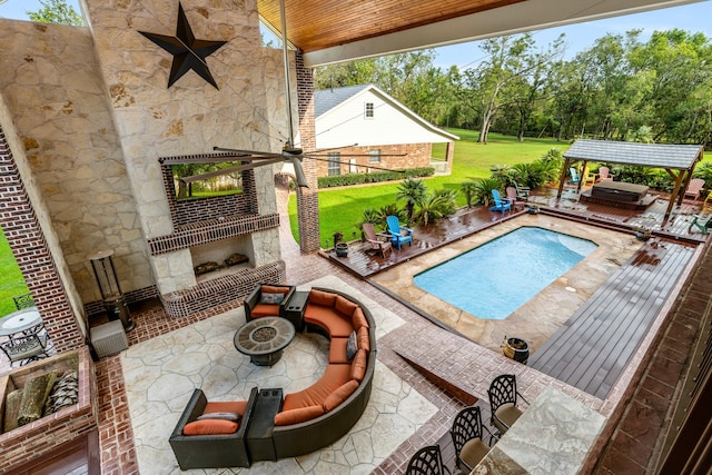 view of pool with a fire pit, a yard, a patio area, and ceiling fan