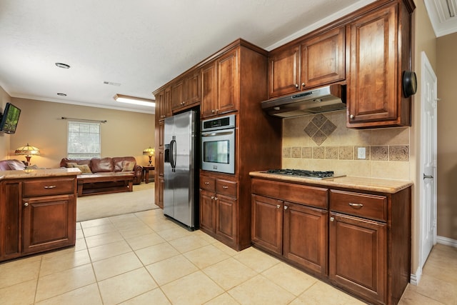 kitchen featuring light tile patterned flooring, appliances with stainless steel finishes, crown molding, and tasteful backsplash