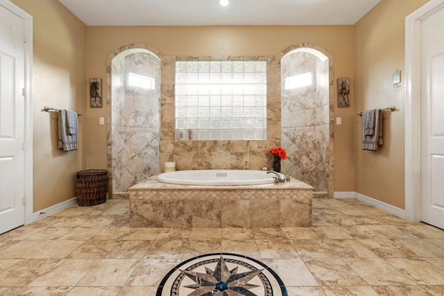 bathroom featuring tiled tub