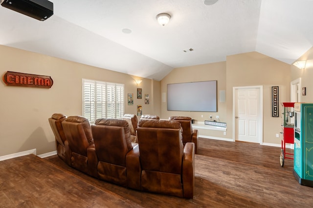 cinema room featuring lofted ceiling and dark hardwood / wood-style floors