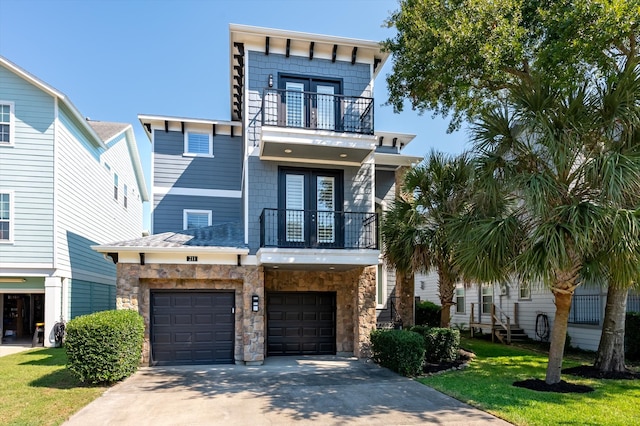 view of front of home with a front yard, a balcony, and a garage