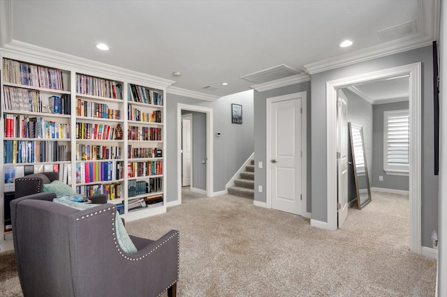 sitting room with crown molding and light colored carpet