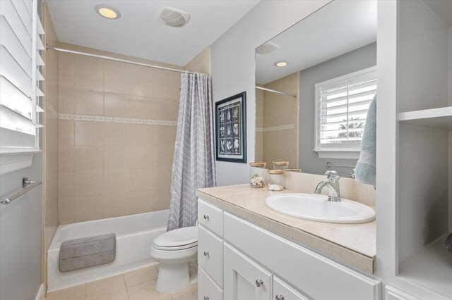 full bathroom featuring shower / bath combo, tile patterned floors, vanity, and toilet