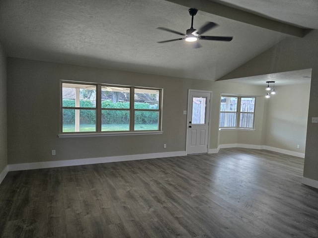 unfurnished living room with ceiling fan with notable chandelier, dark hardwood / wood-style floors, lofted ceiling with beams, and a textured ceiling