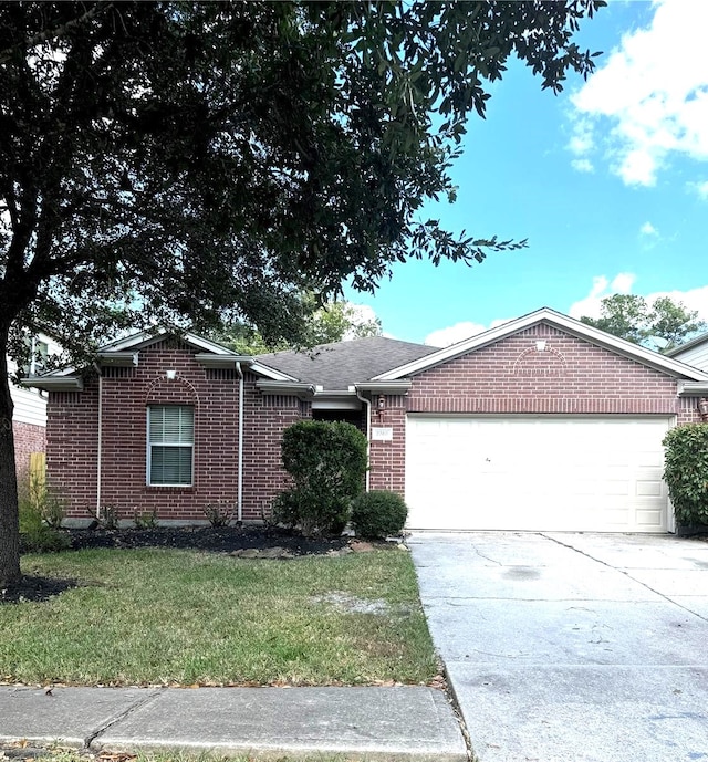 ranch-style house with a garage and a front lawn