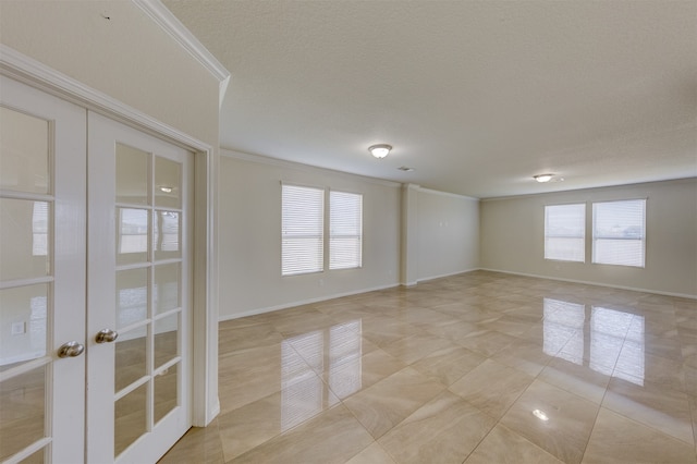 unfurnished room featuring french doors, a textured ceiling, light tile patterned floors, and ornamental molding