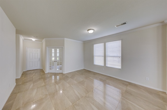 unfurnished room with a textured ceiling, crown molding, and french doors