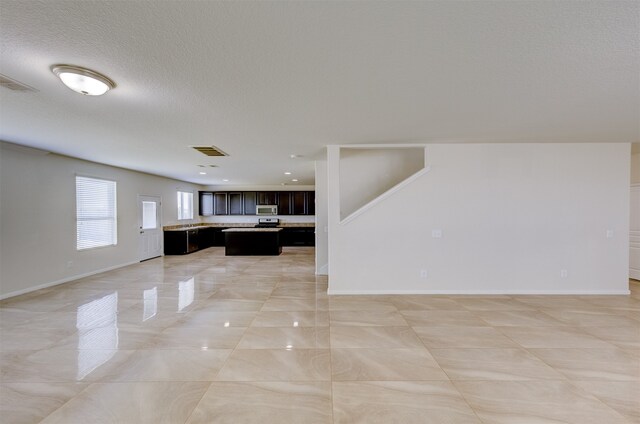 unfurnished living room featuring a textured ceiling