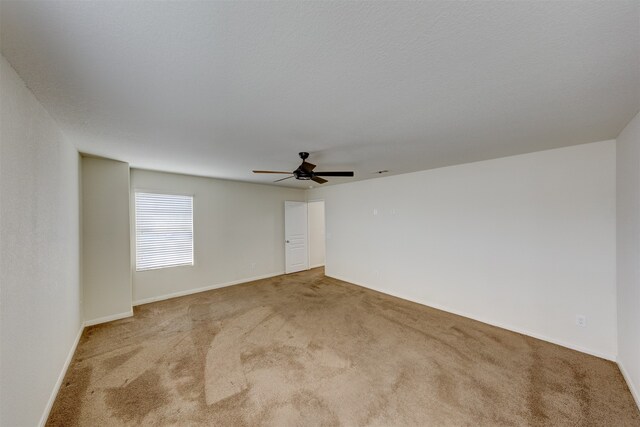 spare room with light carpet and ceiling fan