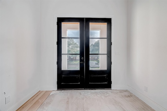 doorway featuring light hardwood / wood-style floors and french doors