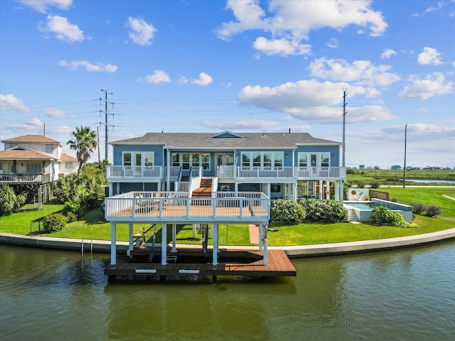 rear view of property featuring a water view and a yard