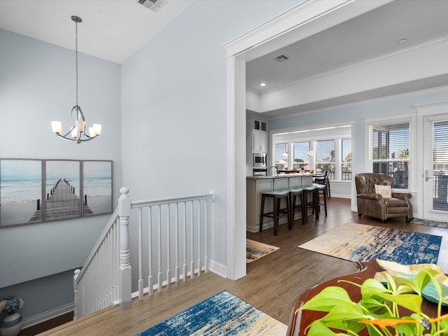 interior space featuring hardwood / wood-style flooring and an inviting chandelier