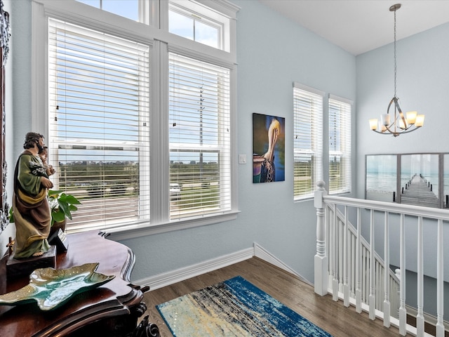 interior space with a chandelier, hardwood / wood-style flooring, and a wealth of natural light