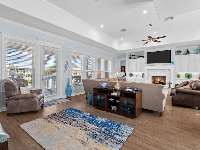 living room featuring crown molding, dark hardwood / wood-style flooring, and ceiling fan