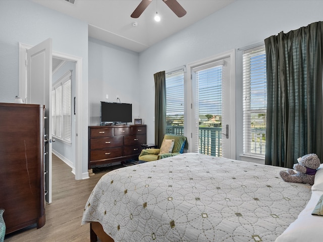 bedroom with ceiling fan, light hardwood / wood-style floors, and access to exterior