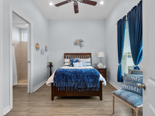 bedroom featuring hardwood / wood-style flooring, ceiling fan, and connected bathroom